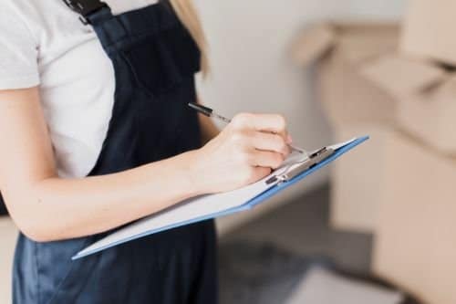 Magic Duster team member using a checklist to prepare a free, custom commercial cleaning quote in NJ.